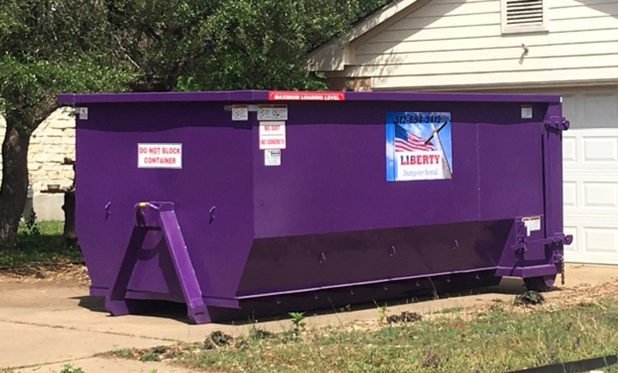 Purple Liberty dumpster ready for pickup in Leander, TX